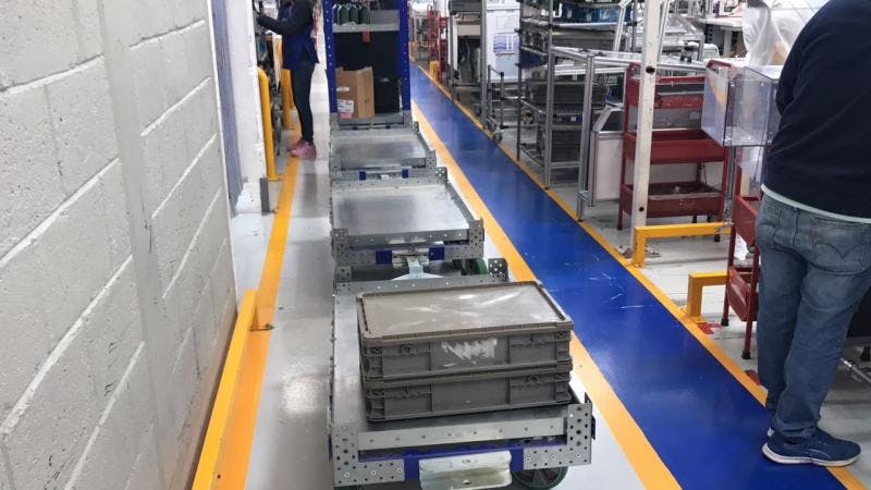 FlexQube tugger carts in a factory